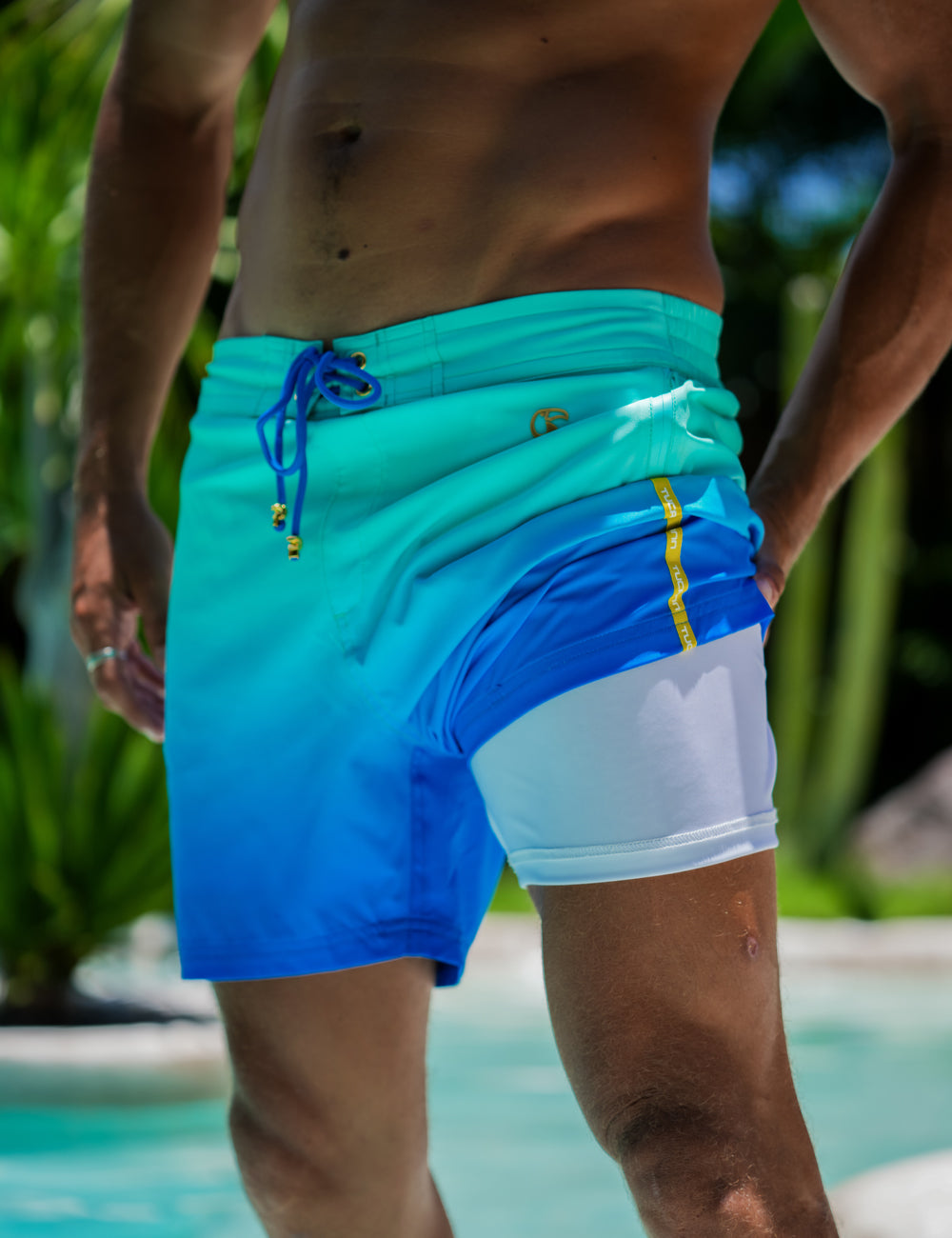 Close-up of men's swim trunks with a blue gradient and white liner.