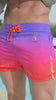 A man wearing faded crimson swim trunks with an orange drawstring.