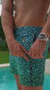 Close-up of a man blue swim trunks featuring a vibrant, eye-catching pattern