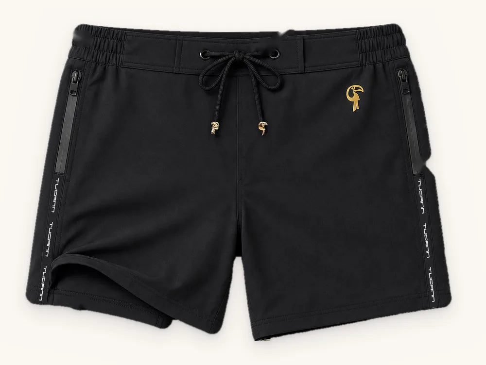 Black Tucann swim trunks laid flat with numbered points on the waistband, drawcord, liner, pocket and fabric